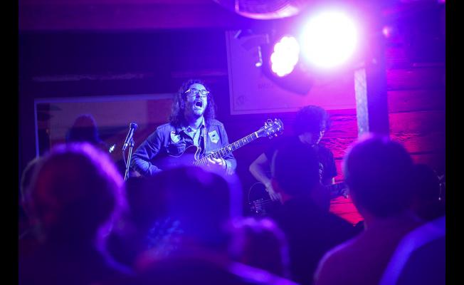 White Denim frontman James Petralli led the quartet on a rockin' set that helped establish the party's vibe.