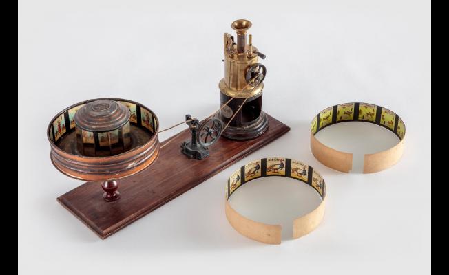 Steam-Driven Praxinoscope with Animation Strips, Ernst Plank, Wood, tin, brass, paint, glass mirror, and cotton string with print on paper strips, c. 1904, Germany, from the Richard Balzer Collection, gift of Patricia S. Bellinger, Photo by Joshua White/JW Pictures, ©Academy Museum Foundation
