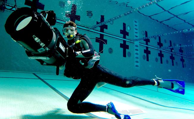 RUNNER-UP SHOOT WINTER 2016 BTS PHOTO CONTEST: "The Underwater Set Today" is a selfie by DP Eduardo Ramirez-Gonzalez working in a underwater commercial shoot in the USC pool in Los Angeles. Shown is the DP, a Red Dragon Camera, and the Hydro flex underwater system. He took the selfie with his Go Pro 3+ Black Edition in time laps mode. The shoot was a proof of concept, for a new product, for all type of athletes. Photo by Eduardo Ramirez-Gonzalez